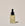 A clear glass bottle with a dropper containing Brightening 2% Vitamin C & Ferulic Acid Serum, labeled ACURE